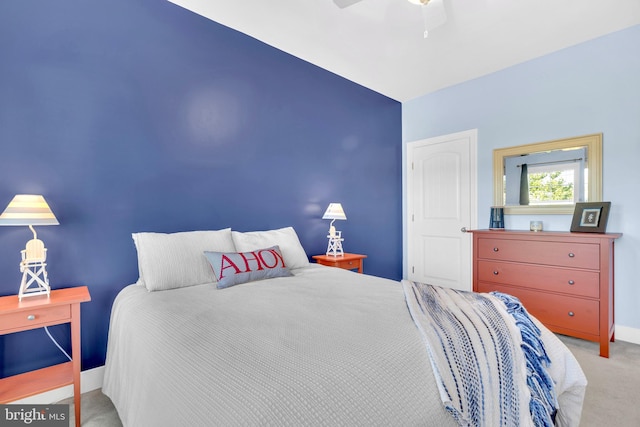 bedroom with vaulted ceiling, ceiling fan, and light colored carpet