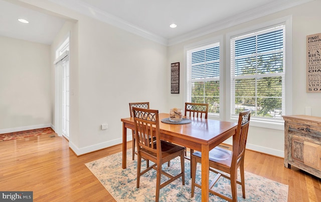 dining room featuring light hardwood / wood-style floors and ornamental molding