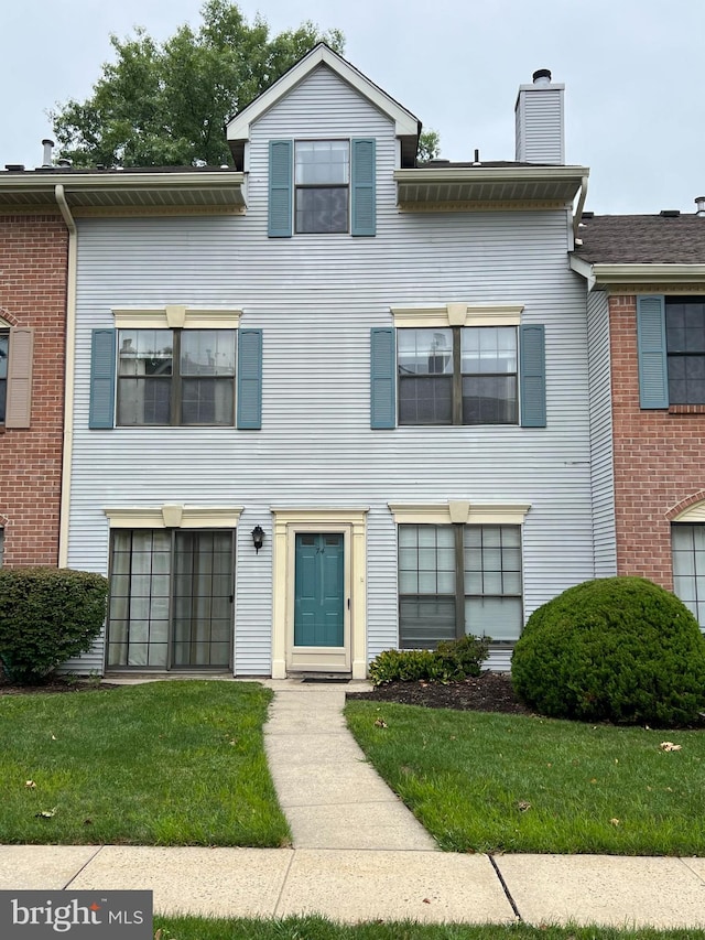 view of front of property with a garage and a front lawn