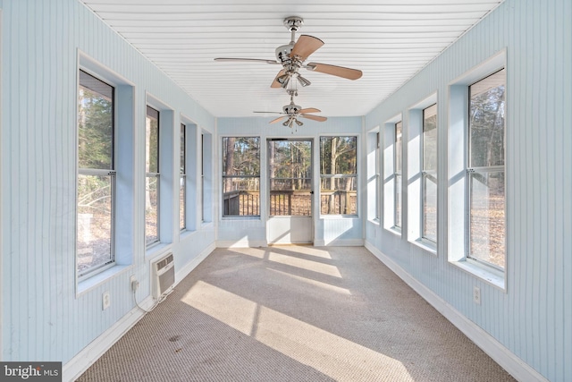 unfurnished sunroom with a wall mounted air conditioner and ceiling fan