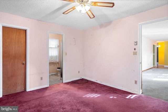 unfurnished bedroom with connected bathroom, ceiling fan, carpet floors, and a textured ceiling