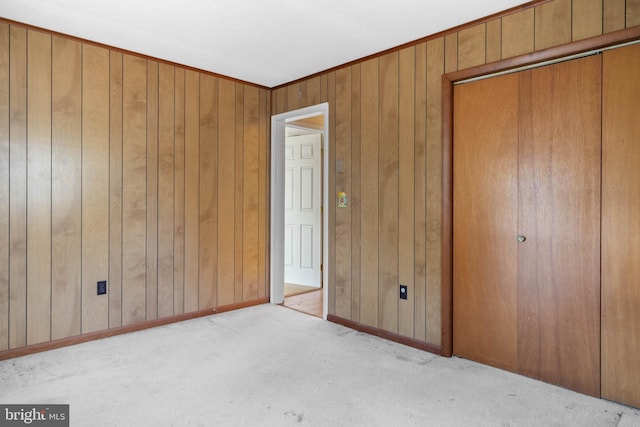 unfurnished bedroom featuring light carpet and a closet