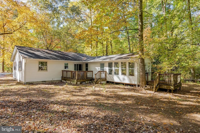 back of house featuring a deck