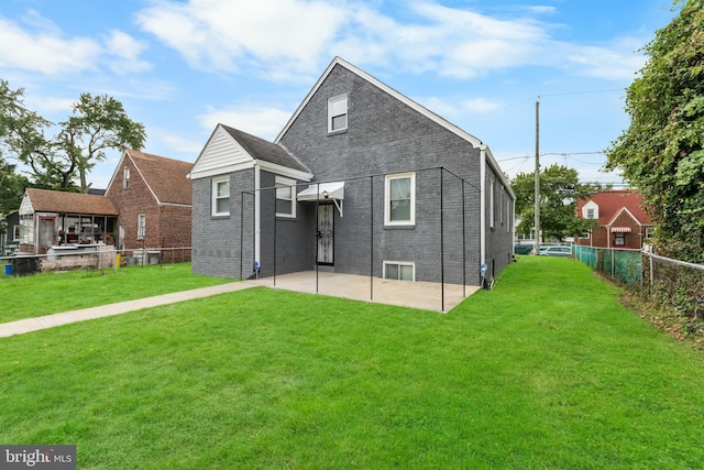 back of property with a patio area and a lawn