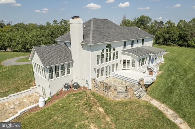 back of property featuring a yard, central AC unit, and french doors