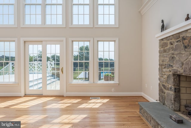 unfurnished living room with a fireplace and light hardwood / wood-style flooring