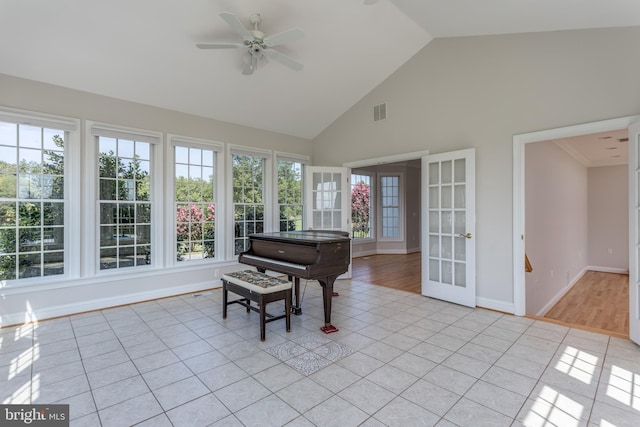 sunroom featuring lofted ceiling and ceiling fan