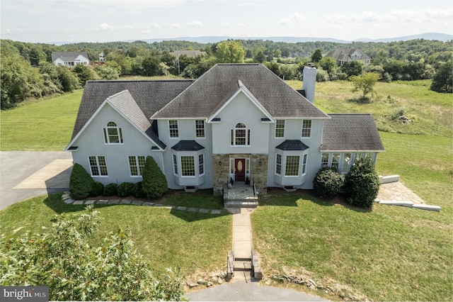 colonial inspired home with a front yard