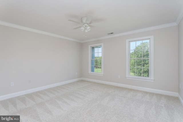 unfurnished room with crown molding, ceiling fan, and light carpet