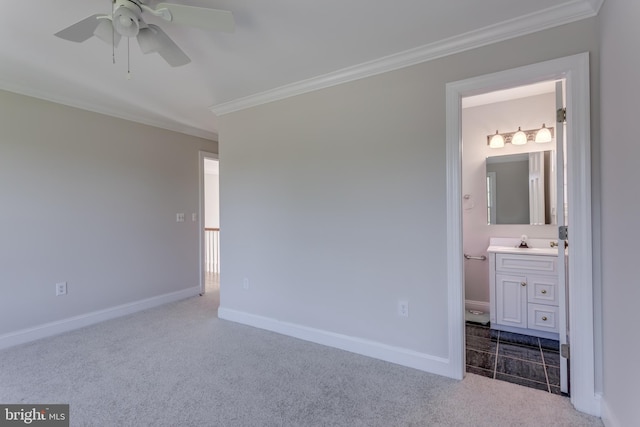 unfurnished bedroom featuring light carpet, ornamental molding, sink, ceiling fan, and ensuite bathroom