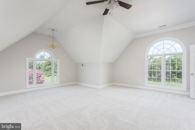 bonus room featuring ceiling fan with notable chandelier, light carpet, and a healthy amount of sunlight