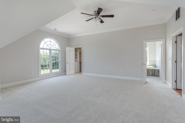 interior space featuring lofted ceiling, ceiling fan, and light colored carpet