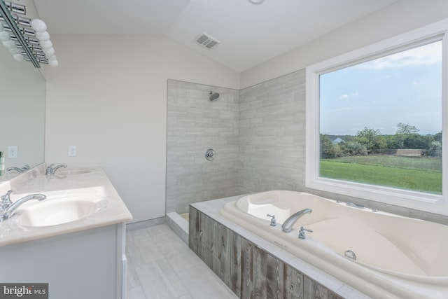 bathroom featuring vanity, lofted ceiling, and independent shower and bath