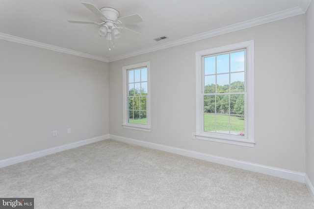 empty room with ceiling fan, light colored carpet, and crown molding