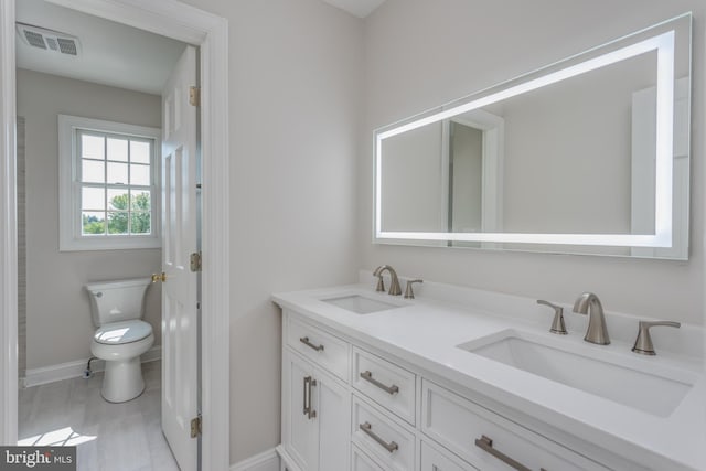 bathroom with vanity and toilet