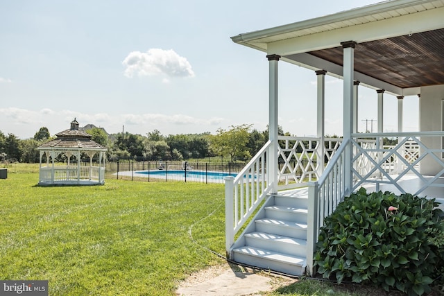 view of yard with a fenced in pool and a gazebo