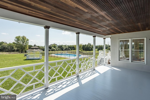 unfurnished sunroom with wooden ceiling