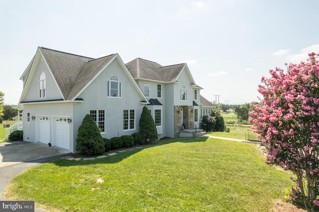 view of front of house with a garage and a front lawn