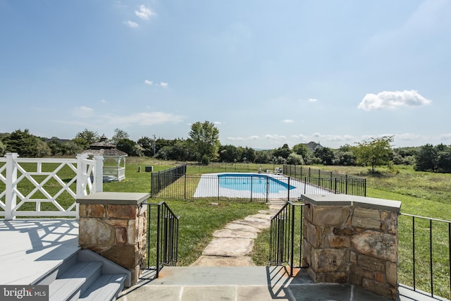 view of swimming pool with a yard