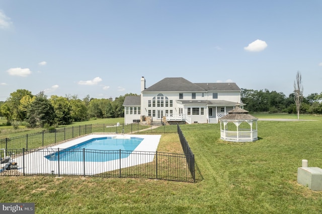 view of swimming pool with a yard