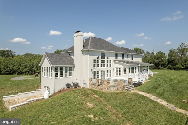 back of house with a lawn and central AC