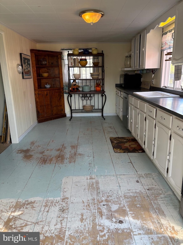 kitchen with baseboards, white cabinets, dishwasher, dark countertops, and open shelves