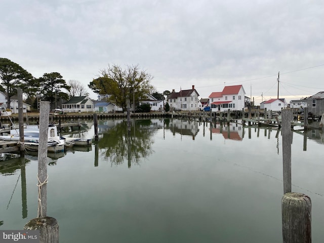 view of water feature with a dock and a residential view