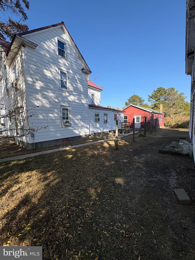 back of property featuring fence