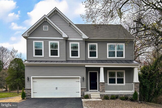 craftsman-style home featuring a front yard and a garage