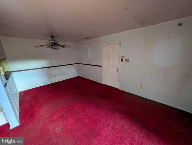 empty room with ceiling fan and carpet floors