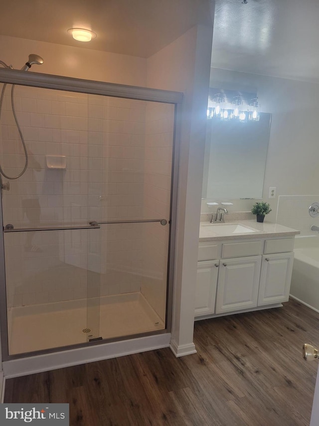 bathroom with a shower with door, vanity, and hardwood / wood-style floors