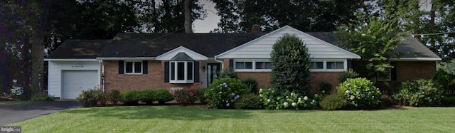 ranch-style house featuring a garage and a front yard