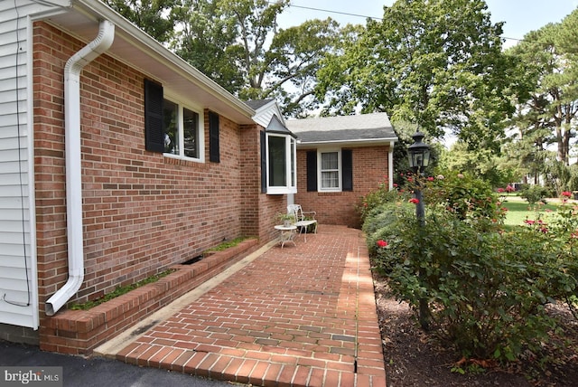 view of home's exterior featuring a patio area and brick siding