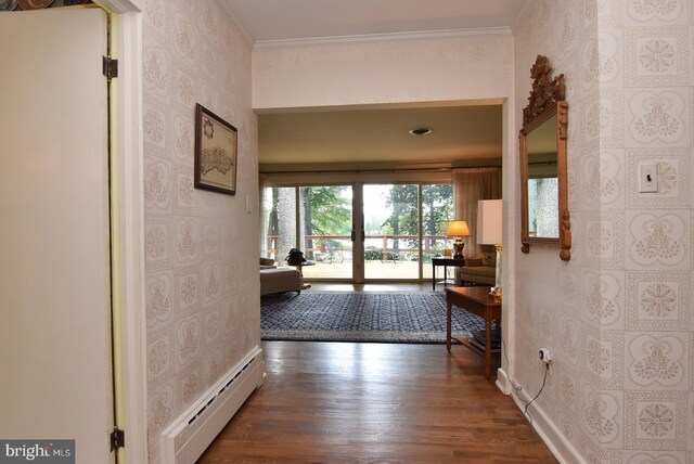 interior space featuring wallpapered walls, a baseboard radiator, ornamental molding, and wood finished floors