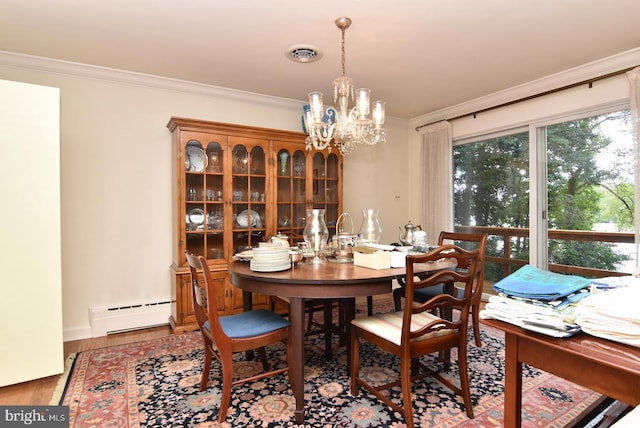 dining area with ornamental molding, wood-type flooring, a baseboard radiator, and a notable chandelier