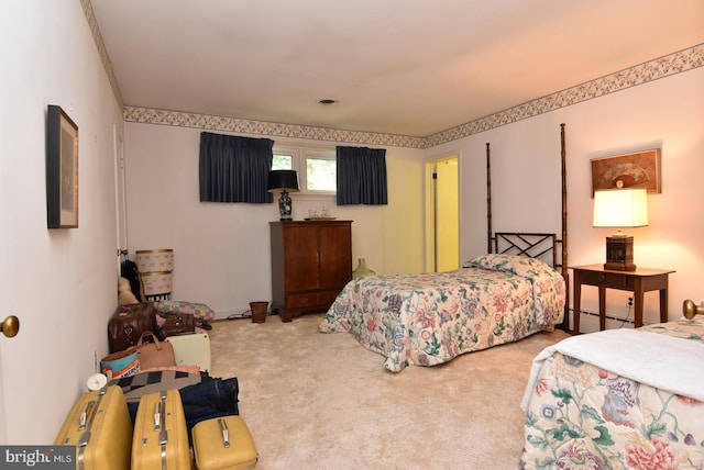 bedroom featuring a baseboard heating unit and carpet flooring