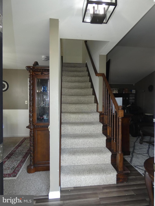 stairway featuring carpet