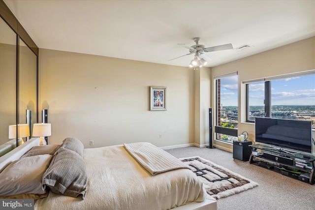 bedroom featuring a ceiling fan, carpet flooring, visible vents, and baseboards