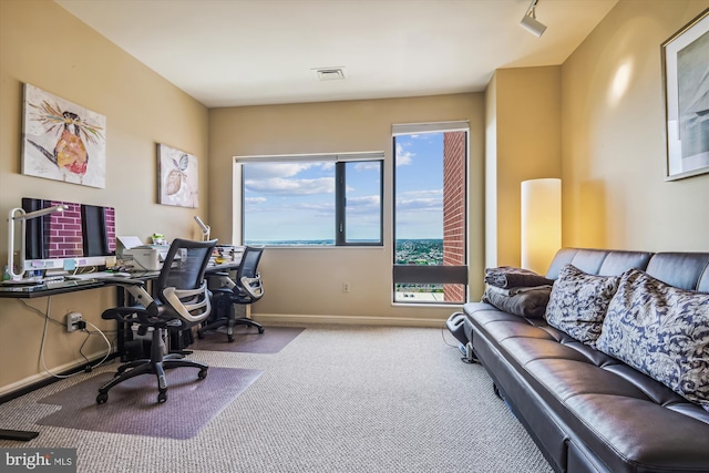 carpeted home office with visible vents and baseboards