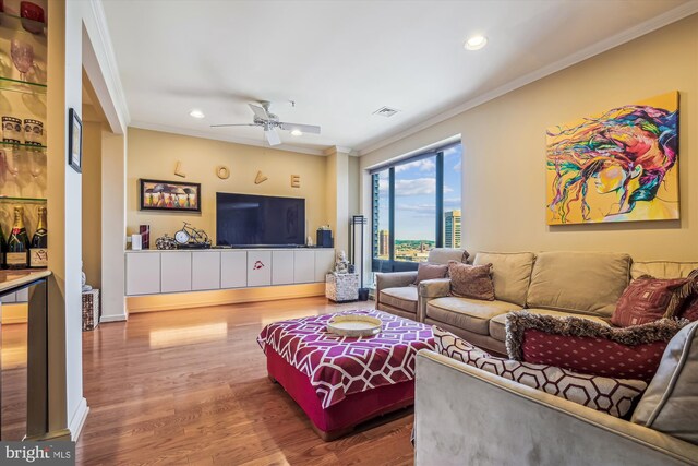 living room with ceiling fan, ornamental molding, hardwood / wood-style floors, and beverage cooler