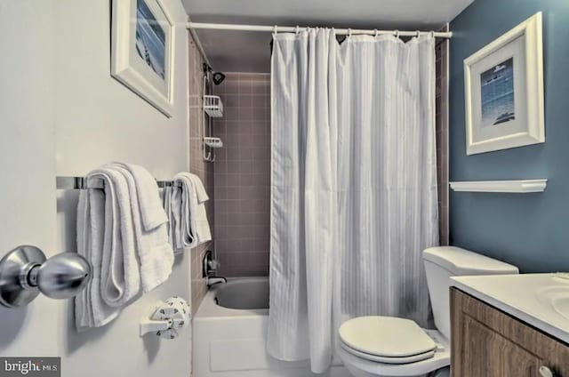 bathroom with shower / bathtub combination with curtain, vanity, and toilet