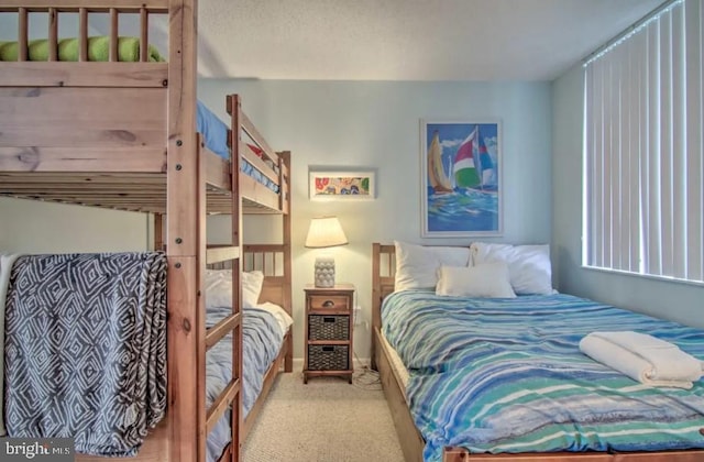 bedroom with baseboards and carpet flooring