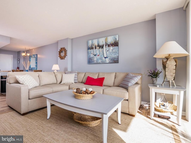 living room with a chandelier and light wood-type flooring