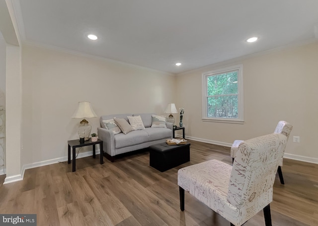 living room with hardwood / wood-style flooring and crown molding