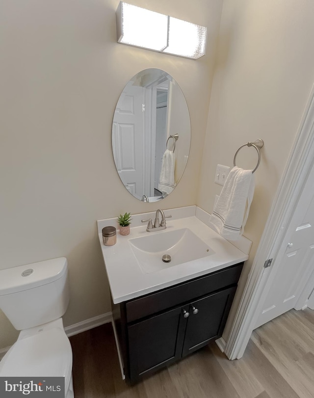 bathroom featuring vanity, toilet, and wood-type flooring