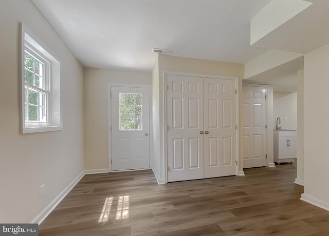 unfurnished bedroom featuring multiple closets and dark hardwood / wood-style flooring