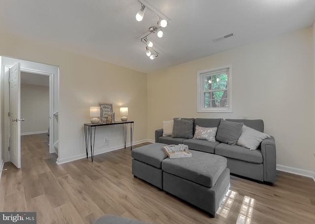 living room featuring track lighting and light hardwood / wood-style flooring