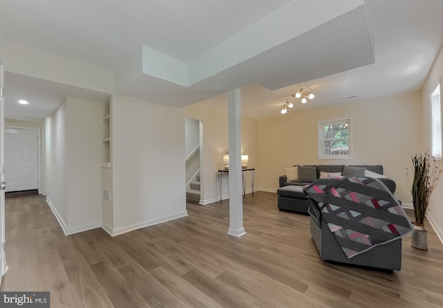 living area featuring light wood-type flooring and track lighting