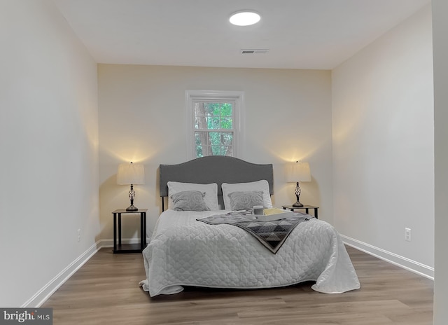 bedroom with hardwood / wood-style floors