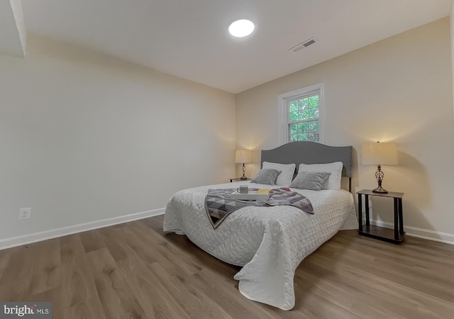 bedroom with hardwood / wood-style floors